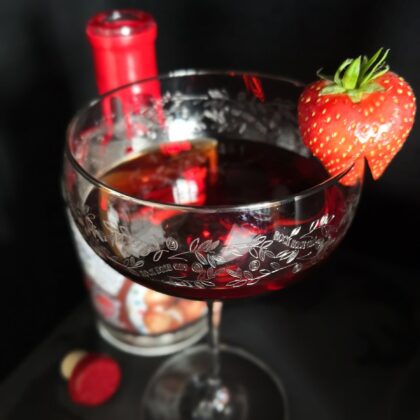 Jam Doughnut Negroni cocktail served in a coupe glass and garnished with a strawberry