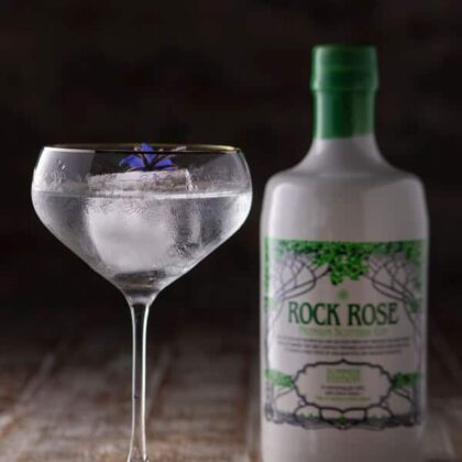 Bottle of Rock Rose Gin Summer Edition and Perfect Serve in a coupe glass