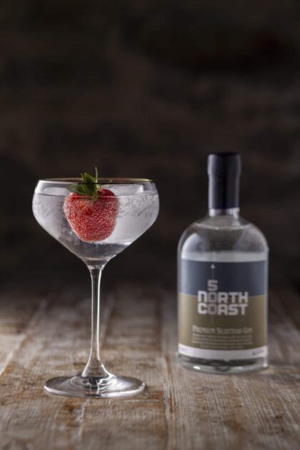 Bottle of 500 North Coast and serve in coupe glass garnished with a strawberry