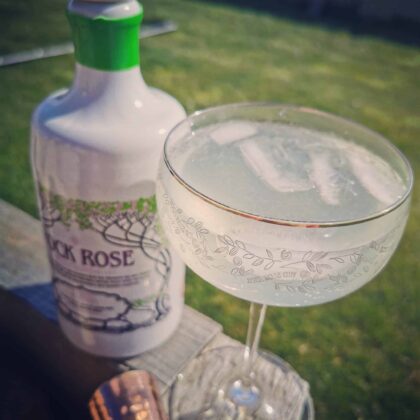 Bottle of Rock Rose Gin Spring edition and Spring tea cocktail served in a coupe glass