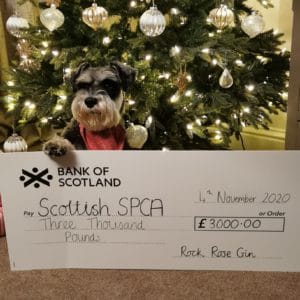 Mr Mackintosh holding a cheque of 3000 pounds for Scottish SPCA