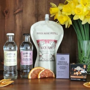Content of the Refill Rewards Club box for March 2021 including Rock Rose Gin pouch, guava lime soda, tonic water, cheese and onion biscuits and Scottish Fudge