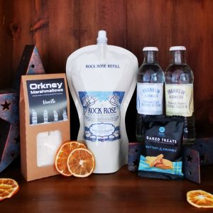 Content of the Refill Rewards Club box for February 2022 including Rock Rose Gin pouch, tonic waters, marshmallows and shortbreads