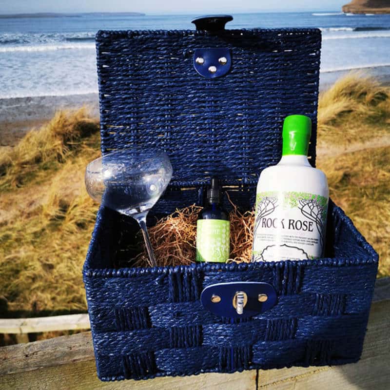 Content of the Gift a Season Hamper a bottle of Rock Rose Seasonal Edition, a branded glass, and matching liquid garnish in a blue hamper