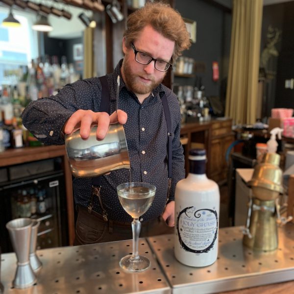 Picture of Kit Stutt owner of The Clockwork Rose bar preparing a cocktail with Holy Grass Vodka