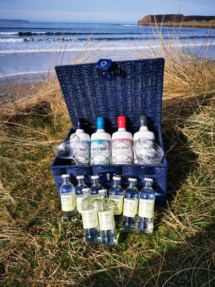 Content of The Signature Collection Hamper including a bottle of Rock Rose Gin Original Edition, and three bottles of Rock Rose special edition, 2 branded glasses and 8 tonic, in a blue hamper