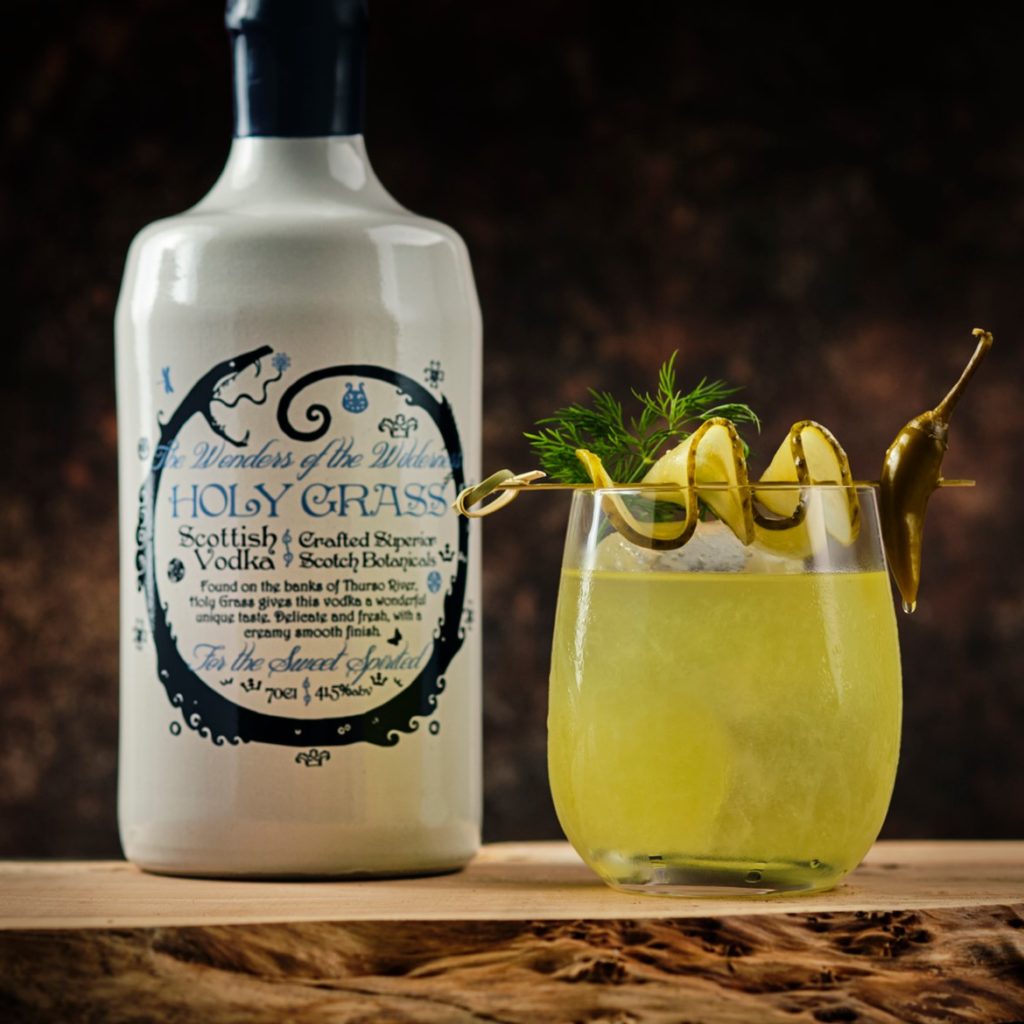 Bottle of Holy Grass Vodka and Caithness Monster cocktail garnished with pickle slices fresh dill & pickled chilli 