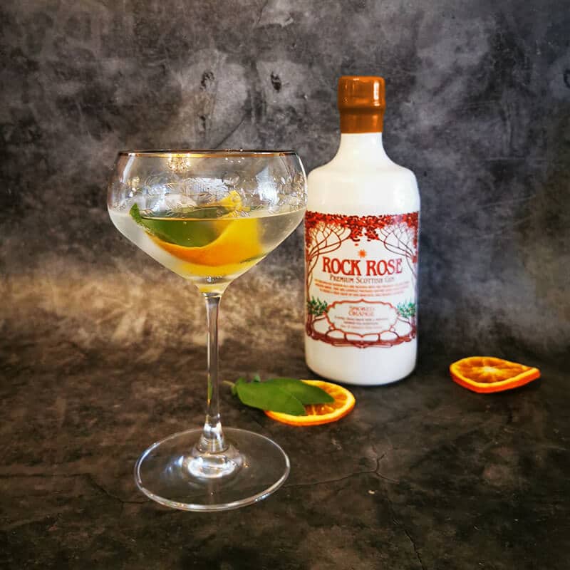 Rock Rose Gin Smoked Orange served in a coupe glass with tonic, a twist of orange peel and sage