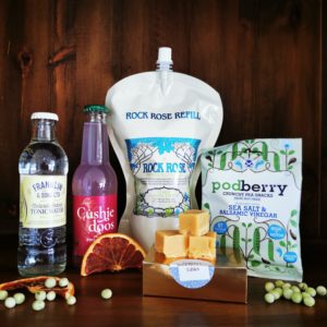 Content of the Refill Rewards Club box for June 2022 including Rock Rose Gin pouch, crunchy pea snack, tablets, tonic water and pinkfruit and rosehip soda
