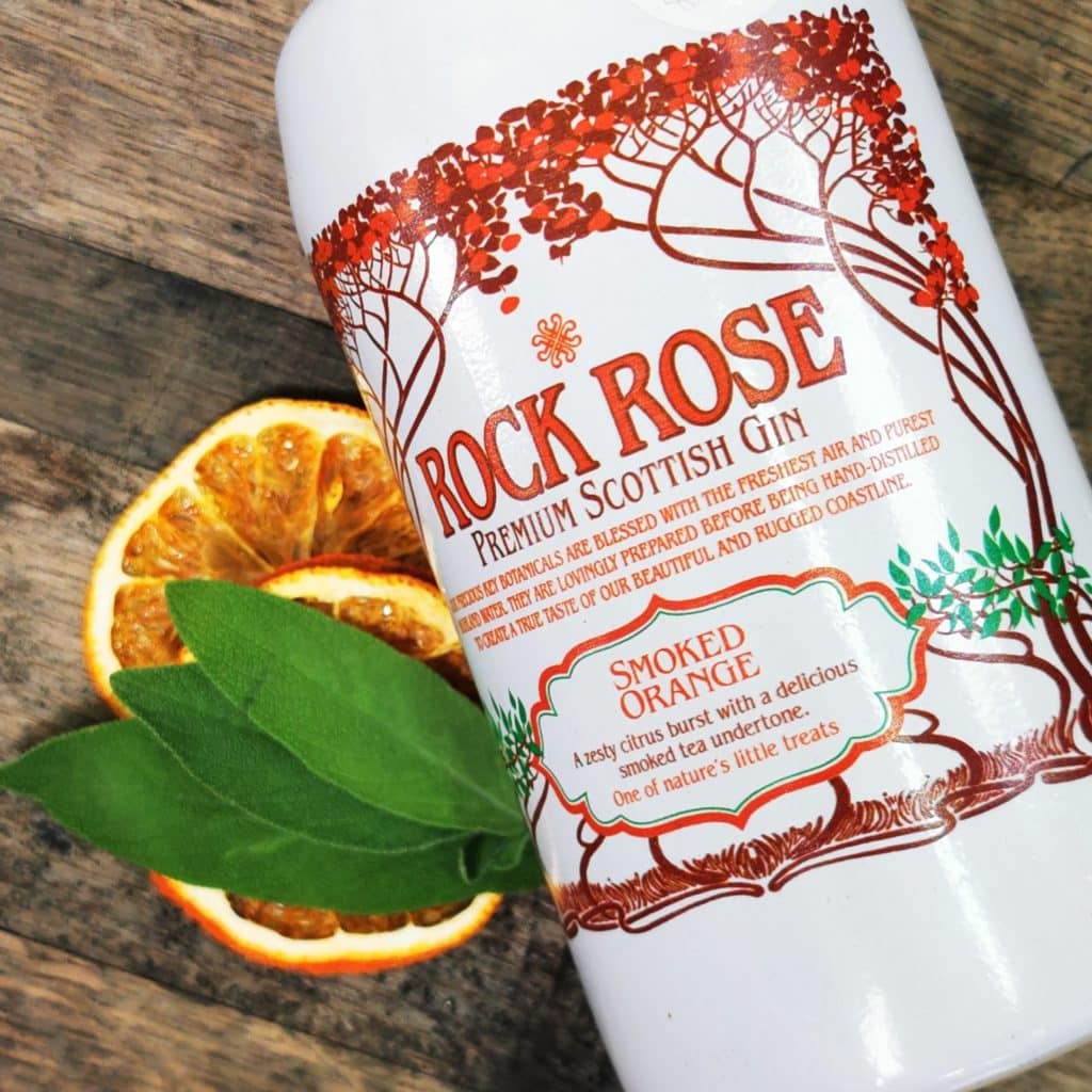 Close up on a bottle of Rock Rose Gin Smoked Orange edition, with slices of orange