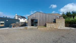 Distillery car park and main entrance to the Visitor Centre with level step-free paved walkway and accessibility ramp
