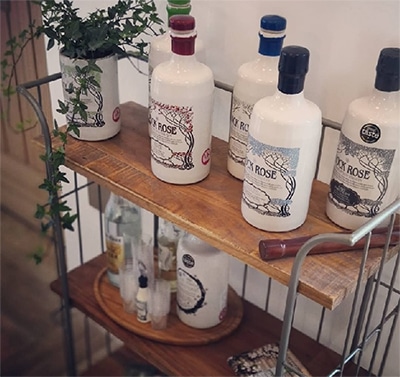 Wooden shelves with selection of Rock Rose Gin bottles