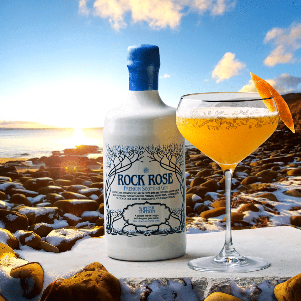 Bottle of Rock Rose Winter edition and Hogmanay Sour cocktail served in branded coupe glass garnished with a slice of orange