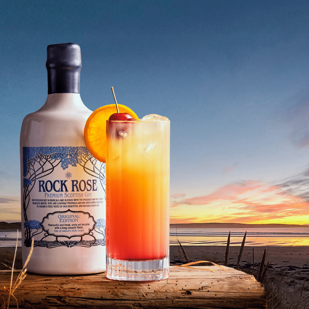 Bottle of Rock Rose Gin original edition and Dunnet Bay Sunset cocktail served in a tall glass and garnished with a slice of orange and a cherry